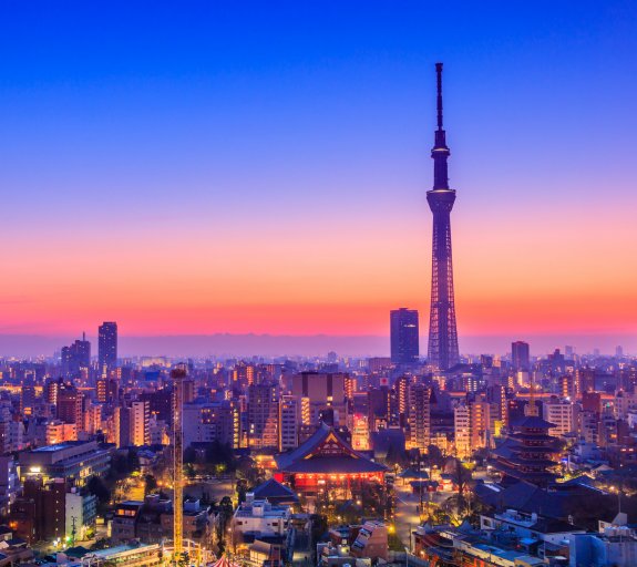 The sun rises over the city of Tokyo in the morning